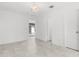 Bright bedroom featuring tile floors, chandelier, and view to the front of the house at 8310 Happy Trails, Kissimmee, FL 34747