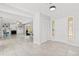Bright foyer showcasing the front door, tiled floors, a coat closet, and views of the living room and dining area at 8310 Happy Trails, Kissimmee, FL 34747