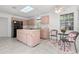 Cozy kitchen with an island, black fridge, and tile flooring at 8310 Happy Trails, Kissimmee, FL 34747