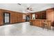 Living room with wood paneling, a bar, and tile flooring at 8310 Happy Trails, Kissimmee, FL 34747