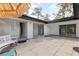 Spacious rear patio with tile flooring and multiple sliding glass doors leading into the home's interior at 8310 Happy Trails, Kissimmee, FL 34747