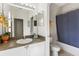 Bathroom with a blue shower curtain, toilet, and vanity at 833 Brunello Dr, Davenport, FL 33897