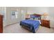 Comfortable bedroom showcasing a bed with blue patterned comforter and two windows at 833 Brunello Dr, Davenport, FL 33897