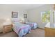 Bright bedroom with two twin beds, side tables, and wall art at 833 Brunello Dr, Davenport, FL 33897