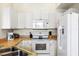 Well-maintained kitchen featuring white appliances, cabinets, and a functional layout with ample counter space at 833 Brunello Dr, Davenport, FL 33897