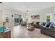 Bright living room with tile flooring, neutral walls, comfortable seating and sliding glass door access at 833 Brunello Dr, Davenport, FL 33897
