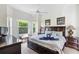 Bright and airy main bedroom featuring a ceiling fan, and large windows with tranquil views at 833 Brunello Dr, Davenport, FL 33897