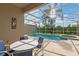 Screened in pool with outdoor seating and a spa at 833 Brunello Dr, Davenport, FL 33897