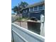 View of the back of a blue house with a fenced-in backyard and deck at 848 Wildabon Ave, Lake Wales, FL 33853