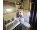 Bathroom features a toilet, vanity, mirror and half wall paneling at 848 Wildabon Ave, Lake Wales, FL 33853