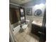 Bathroom features a shower, toilet, vanity, mirror and tile flooring at 848 Wildabon Ave, Lake Wales, FL 33853