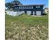 A two story home with two garage doors and a white fence in the backyard at 848 Wildabon Ave, Lake Wales, FL 33853