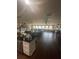 Open floor plan featuring the living room and kitchen, with hard wood floors and many windows at 848 Wildabon Ave, Lake Wales, FL 33853