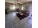 Cozy living room with tile flooring, a ceiling fan, and warm, inviting decor at 848 Wildabon Ave, Lake Wales, FL 33853