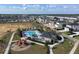 Aerial view of a residential community featuring a playground and community pool at 895 Overpool Ave, Davenport, FL 33896