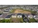 Aerial view of a suburban neighborhood with a grassy field and community pool that offers a play area at 895 Overpool Ave, Davenport, FL 33896