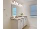 Bright bathroom featuring double vanity, granite countertops, and updated fixtures at 895 Overpool Ave, Davenport, FL 33896