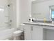 Well-lit bathroom with shower-tub combination, granite countertop and white cabinets at 895 Overpool Ave, Davenport, FL 33896