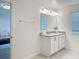 Well-lit bathroom with a granite countertop vanity, decorative mirror, and stylish light fixtures at 895 Overpool Ave, Davenport, FL 33896
