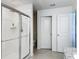 Well-appointed bathroom with a glass shower enclosure, toilet, and white doors at 895 Overpool Ave, Davenport, FL 33896