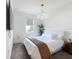 Bright bedroom featuring a plush bed, soft lighting, and a large window at 895 Overpool Ave, Davenport, FL 33896