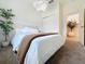 Cozy bedroom featuring a plush bed, soft lighting, and a view to the foyer at 895 Overpool Ave, Davenport, FL 33896