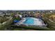 A nice pool with lounge chairs and umbrellas surrounding the pool with greenry around it at 895 Overpool Ave, Davenport, FL 33896