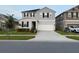 Lovely two-story home features a two car garage, manicured lawn and landscaping at 895 Overpool Ave, Davenport, FL 33896