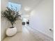 Bright foyer with tiled floors, decorative tree, and chandelier lighting creates a welcoming entrance at 895 Overpool Ave, Davenport, FL 33896