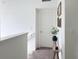 Bright hallway featuring decorative wall art and a small bench, adding a touch of elegance and convenience at 895 Overpool Ave, Davenport, FL 33896
