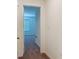 Hallway featuring neutral paint leading to a bedroom with carpet at 895 Overpool Ave, Davenport, FL 33896
