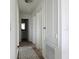 Hallway with a view of the bathroom, featuring a modern light fixture and neutral color palette at 895 Overpool Ave, Davenport, FL 33896