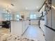 Bright, updated kitchen featuring white cabinets, granite countertops, and stainless steel appliances at 895 Overpool Ave, Davenport, FL 33896
