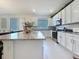 Bright and updated kitchen with large granite island and modern appliances at 895 Overpool Ave, Davenport, FL 33896