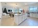 Open-concept kitchen with granite countertops, stainless steel appliances, and seamless access to the living room at 895 Overpool Ave, Davenport, FL 33896