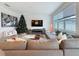Inviting living room featuring a large sectional sofa, a fireplace, and ample natural light at 895 Overpool Ave, Davenport, FL 33896