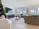 Comfortable living room featuring a fireplace, large windows, and cozy seating at 895 Overpool Ave, Davenport, FL 33896