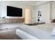 Modern main bedroom showcasing floating cabinets, television, and neutral finishes at 895 Overpool Ave, Davenport, FL 33896