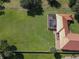 Expansive landscaped yard with pool and screen enclosure, set in a peaceful and serene setting at 955 Mansfield Rd, Tavares, FL 32778
