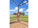 Landscaped backyard featuring an American flag, eagle statue, and clear skies at 955 Mansfield Rd, Tavares, FL 32778