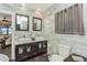 Elegant bathroom featuring marble walls, a double vanity, and a toilet at 955 Mansfield Rd, Tavares, FL 32778