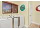 Comfortable bathroom featuring a walk-in tub, window with blinds, and elegant decorative mirrors at 955 Mansfield Rd, Tavares, FL 32778