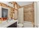 Well-lit bathroom with a tiled shower, vanity, and toilet with bidet at 955 Mansfield Rd, Tavares, FL 32778