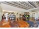 Large garage with an epoxy floor, housing a truck, golf cart, and providing workspace at 955 Mansfield Rd, Tavares, FL 32778