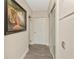 Hallway featuring sliding closet doors and neutral paint at 955 Mansfield Rd, Tavares, FL 32778