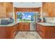 Stylish kitchen boasts granite countertops, stainless steel appliances, wood cabinets and stunning views at 955 Mansfield Rd, Tavares, FL 32778