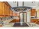 Well appointed kitchen featuring stainless steel appliances, granite countertops, and custom wood cabinets at 955 Mansfield Rd, Tavares, FL 32778