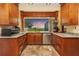 Stylish kitchen boasts granite countertops, stainless steel appliances, wood cabinets and stunning water views at 955 Mansfield Rd, Tavares, FL 32778