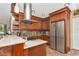 Spacious kitchen featuring stainless steel appliances, custom wood cabinets and granite countertops at 955 Mansfield Rd, Tavares, FL 32778