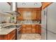 Spacious kitchen featuring stainless steel appliances, custom wood cabinets and granite countertops at 955 Mansfield Rd, Tavares, FL 32778